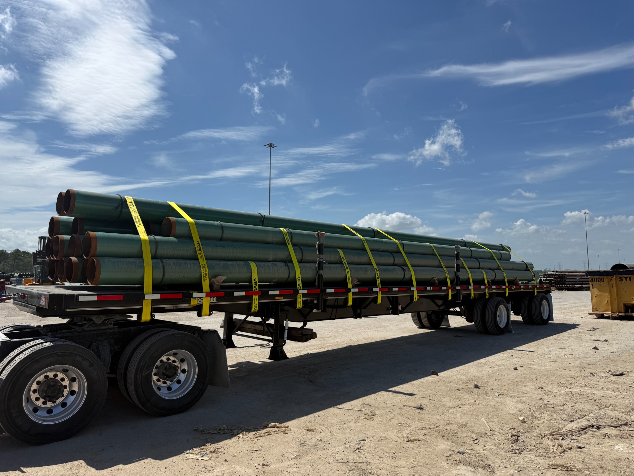 Actual Ashley Transport pipe load with straps over the top and through intermediate tiers